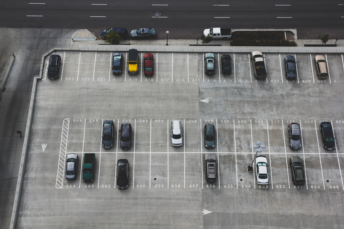A car driving down a dim underground parking garage ramp